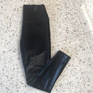Beyond Yoga brand black, shiny leggings.  Size Large